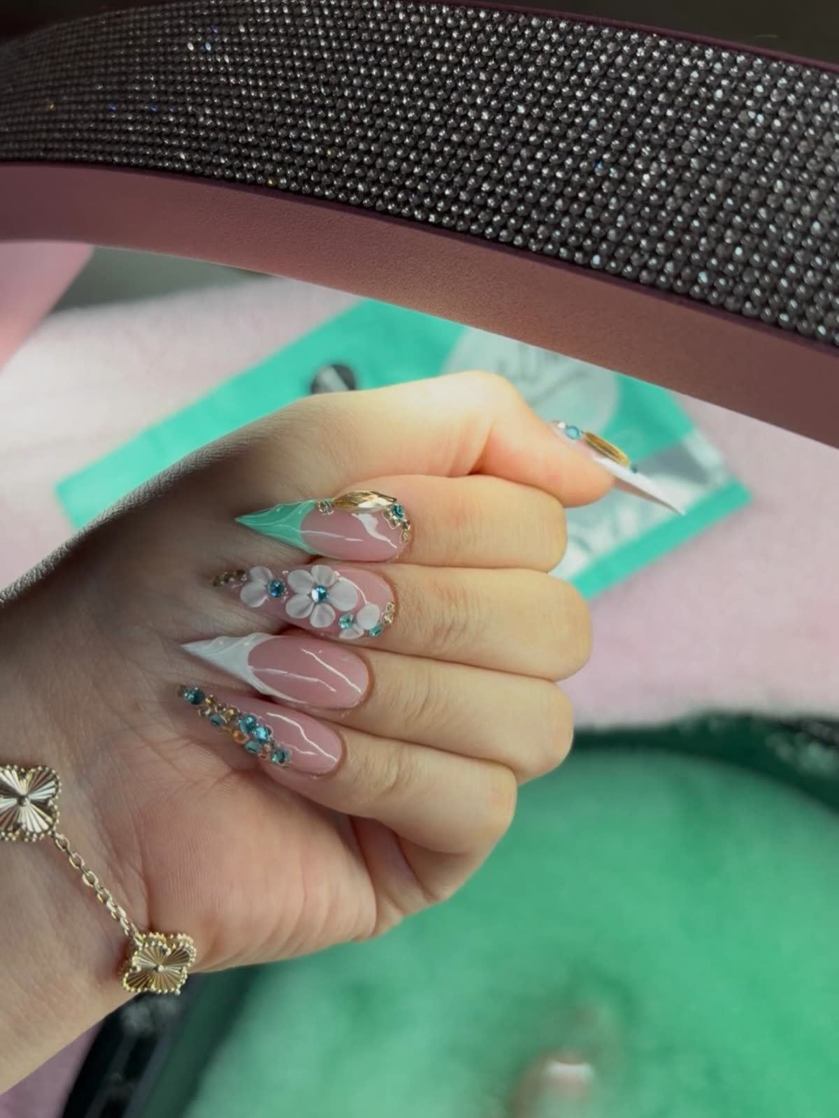 Stiletto nails with 3D white flowers and turquoise rhinestones