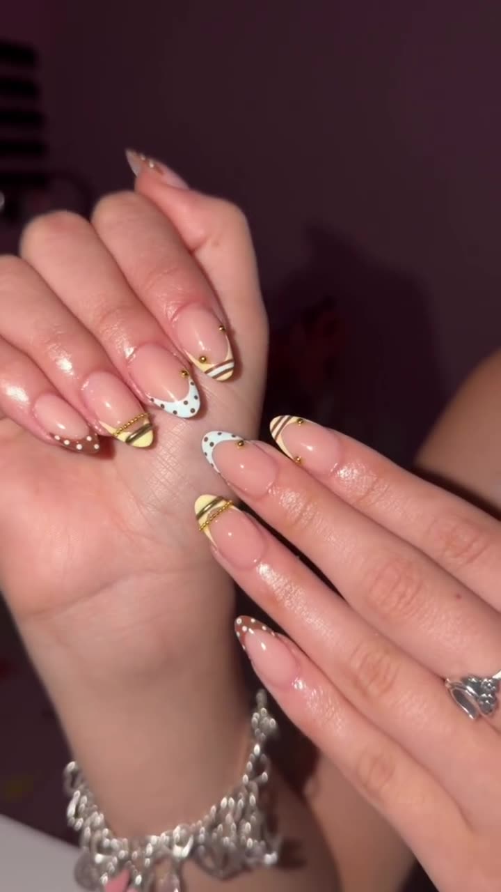 Almond nails with gold French tips and crystals